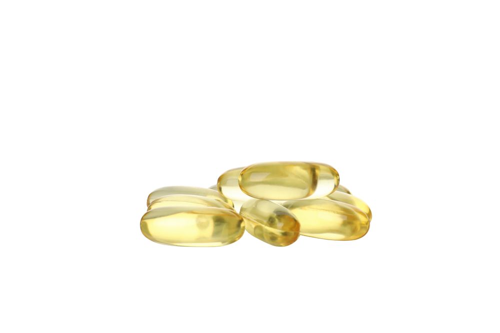 Omega pills close-up, isolated on blank background