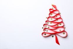 Christmas tree made from red ribbon and glitter on light background, space for text