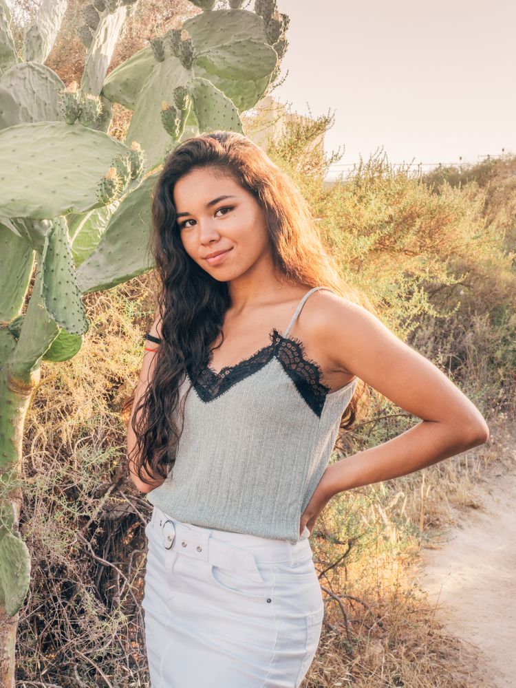 Playful trendy young woman in deserted countryside