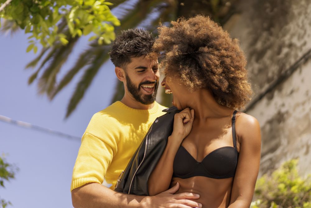 Happy couple flirting on street