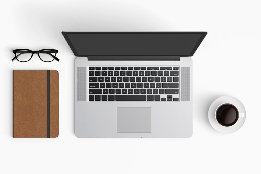 Modern workspace with coffee cup, smartphone, paper, notebook, tablet and laptop copy space