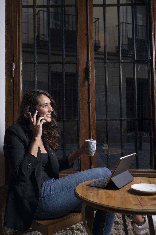 Young female using a mobile phone in cafe