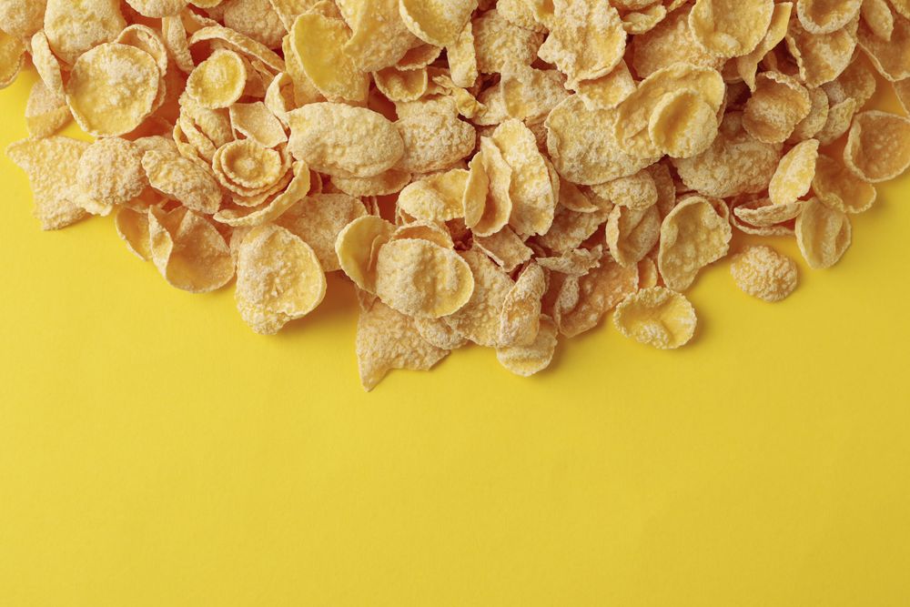 Tasty muesli on yellow background, top view