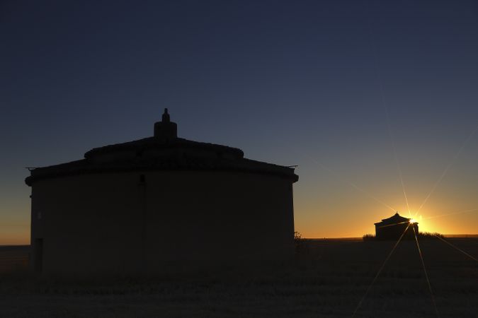 Aged house in rural countryside under starry sky