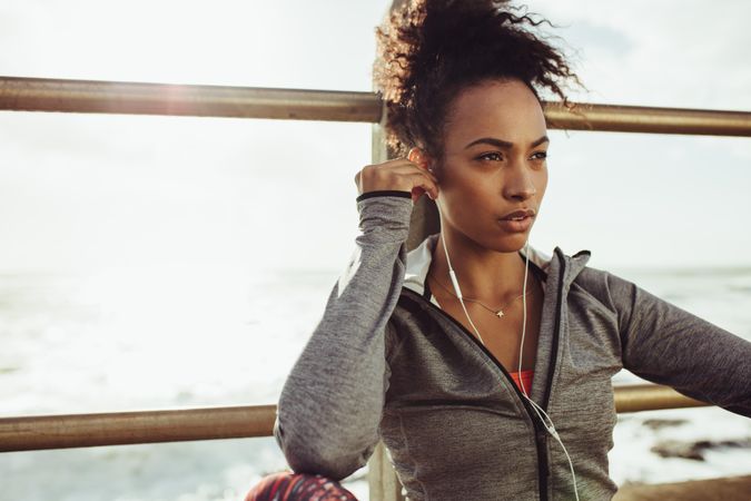 Female listening to music during workout break