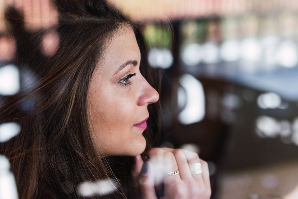 Woman looking through window