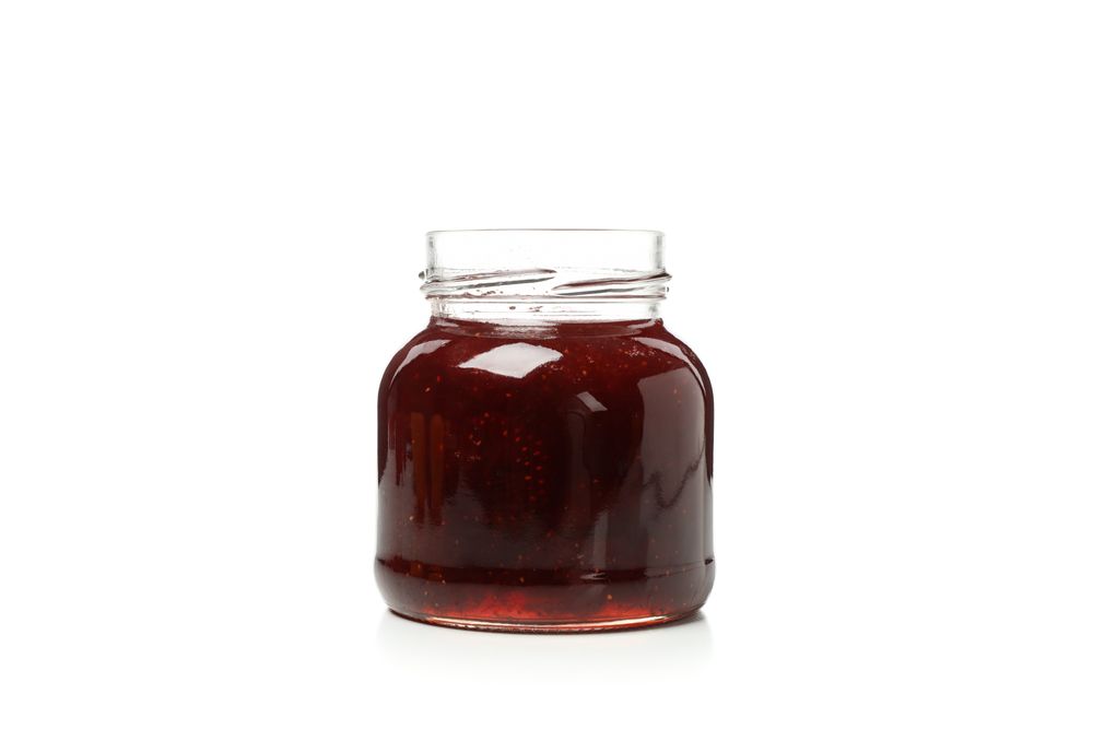 Delicious strawberry jam isolated on plain background