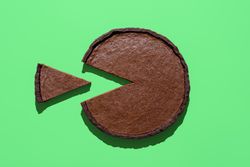 Homemade chocolate cake above view, minimalist on a green background