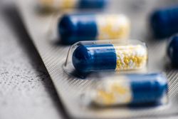 Close up of blue pills on grey counter