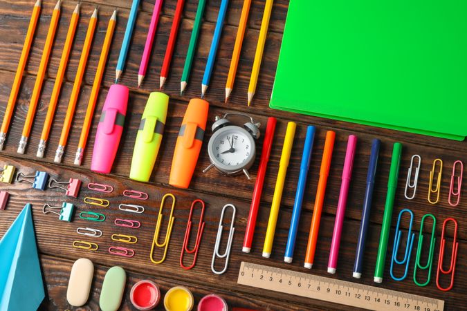 Flat lay composition with school supplies on wooden background