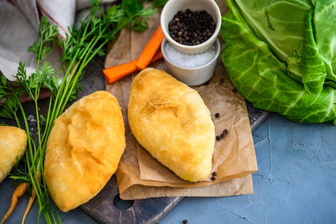 Savory pies with cabbage and carrot on kitchen counter