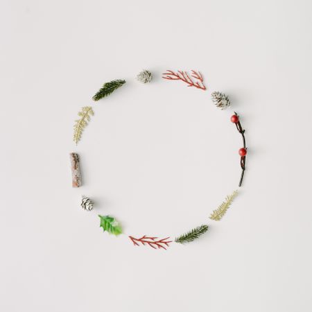 Minimal festive wreath made of branches, pine cones and leaves