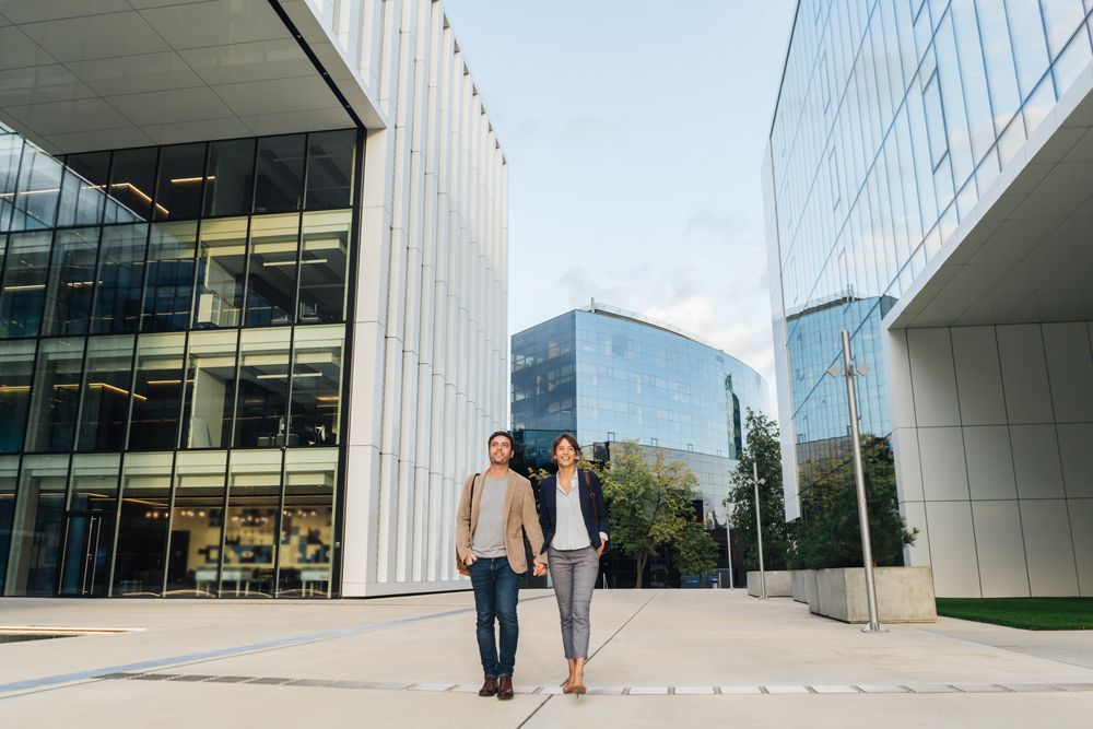 Businesspeople couple outside contemporary building