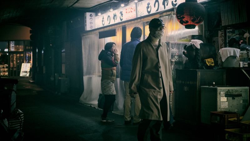 People standing beside store in Japan at night