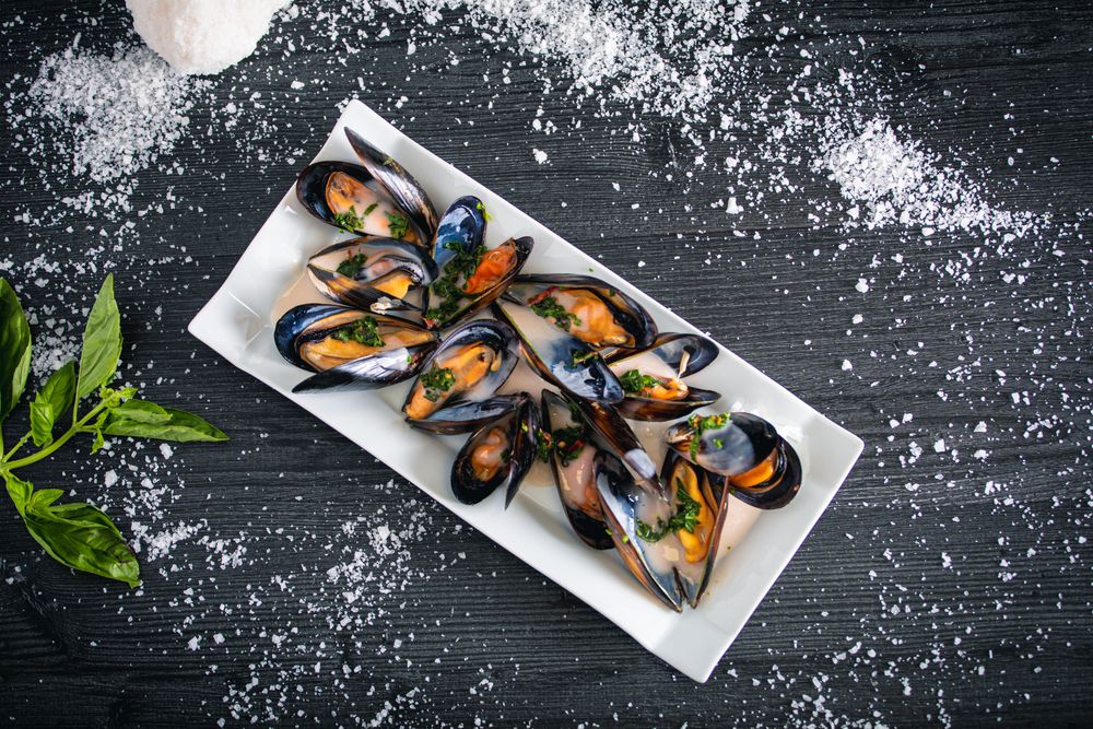 Steamed mussels with Thai sauce in plate