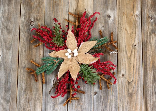 Christmas wreath with cloth flower on rustic wood