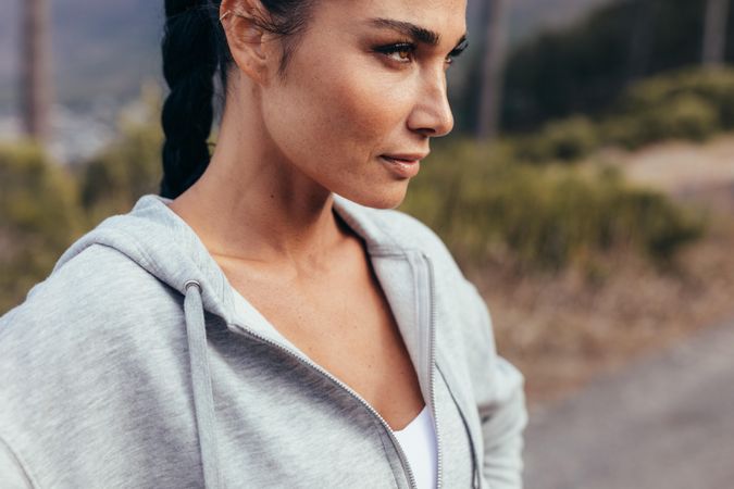 Close up of determined woman getting ready to run outdoors