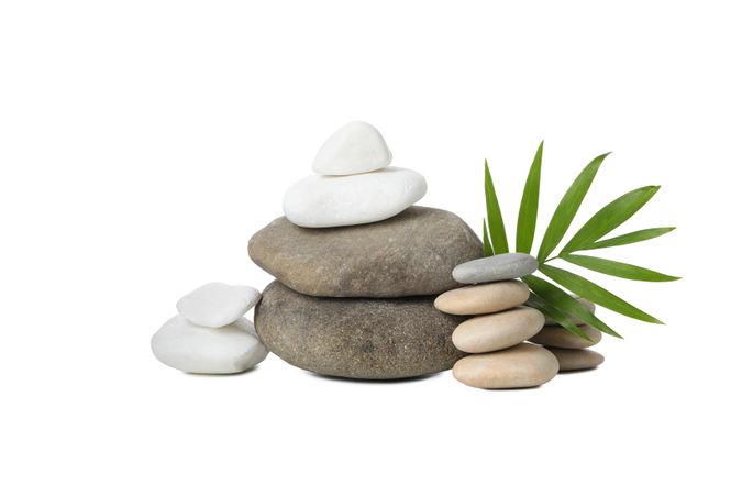 Stones and tropical leaf, isolated on plain background