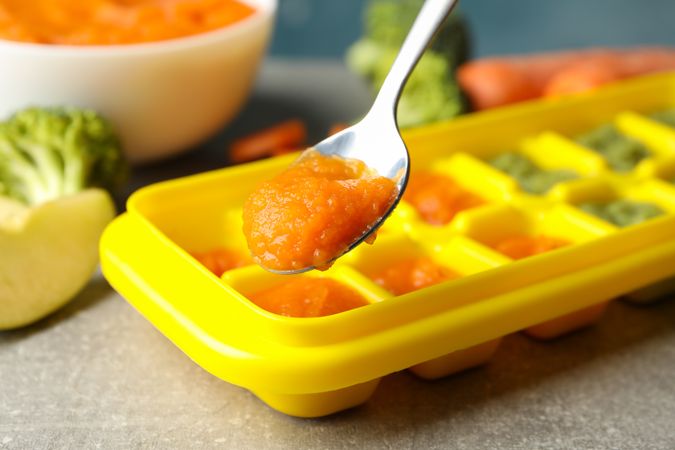 Composition with baby food on gray background, close up