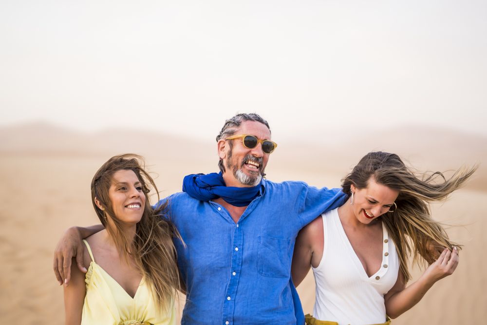 Happy friends walking in desert