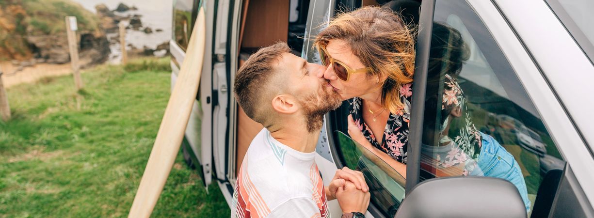 Banner of male and female kissing out motorhome window