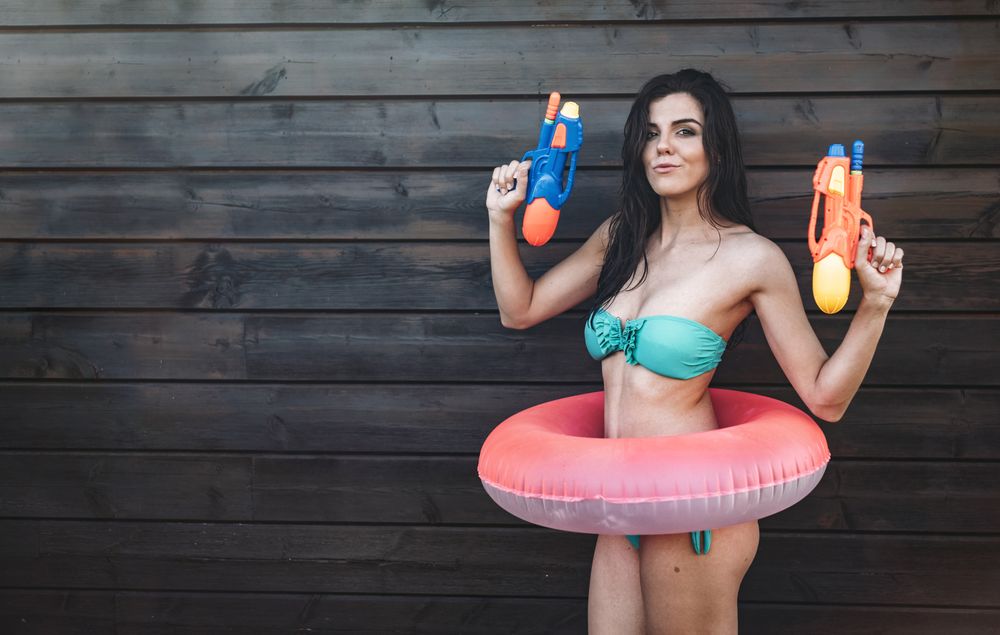 Young woman with two water guns posing