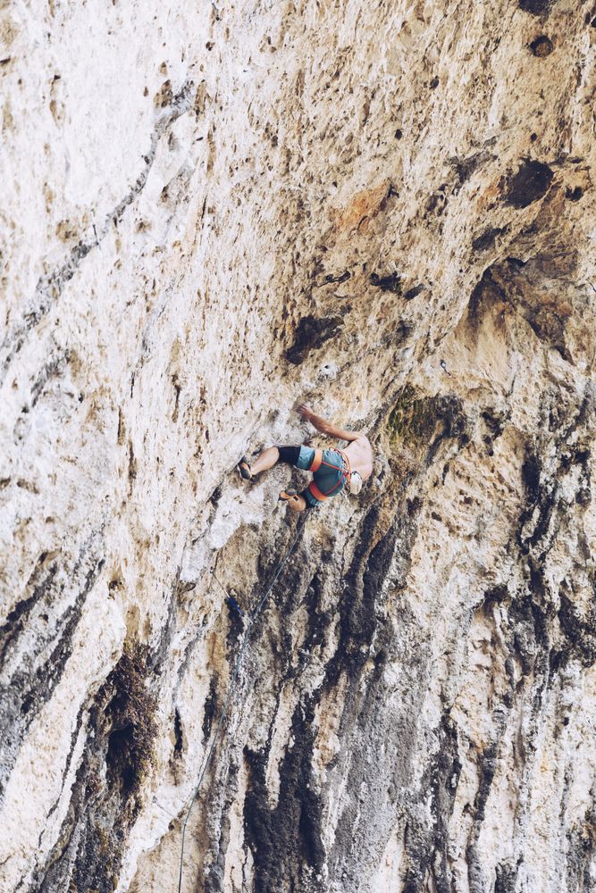 Anonymous man climbing rock