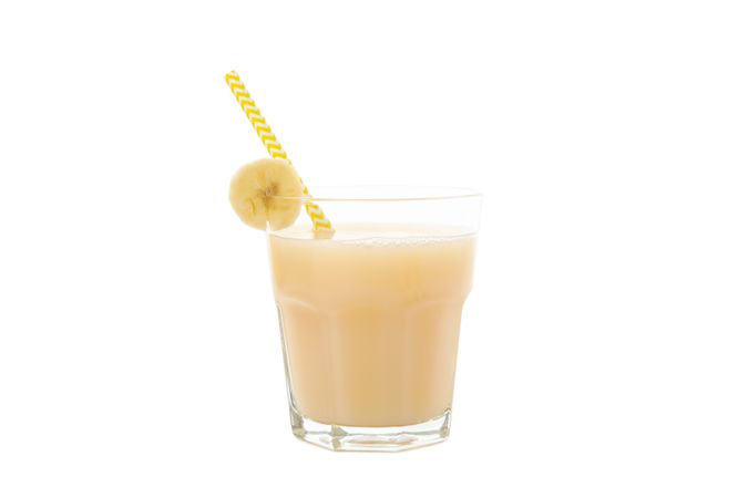 Banana juice isolated on blank background. Fresh fruit
