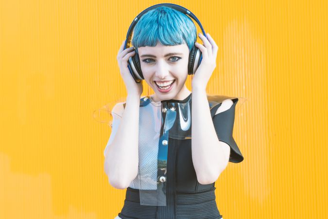 Cool informal woman in headphones on street