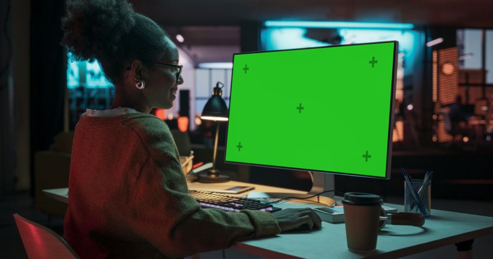 Over the Shoulder: Female Specialist Working on Computer with Chroma Key Display at Creative Agency.