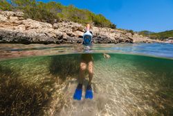 Anonymous person in snorkeling mask in ocean