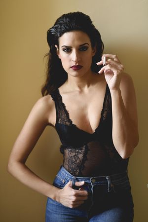 Brunette female wearing lace top and blue jeans