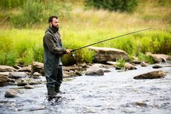 Fisherman Standing in Mountain River