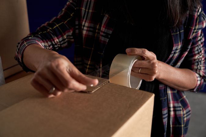Anonymous woman packing carton box