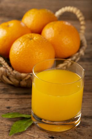 Glass with orange juice on the table.