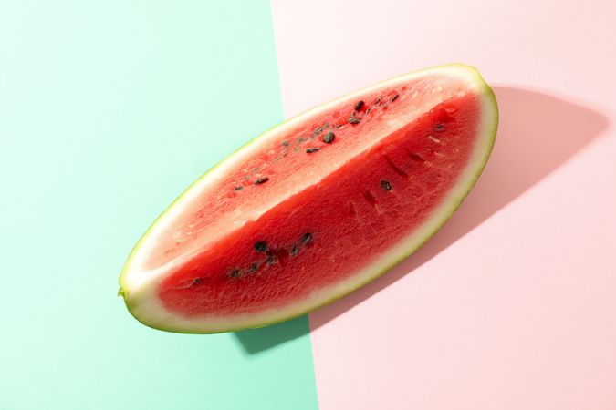 Fresh watermelon slice on two tone background. Summer fruit