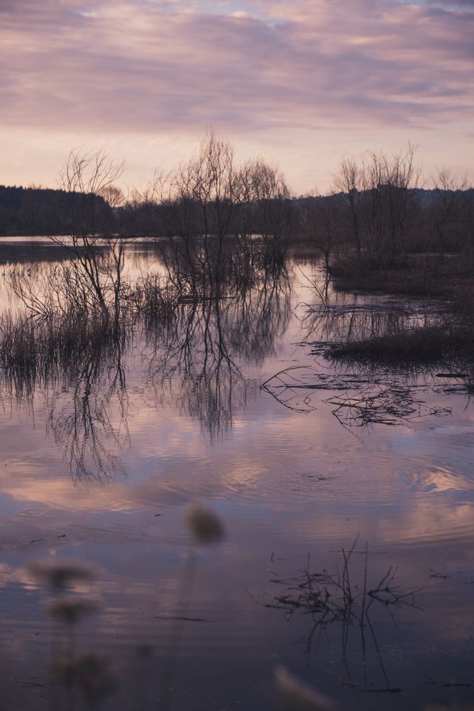 Cloudy evening sky over calm lake