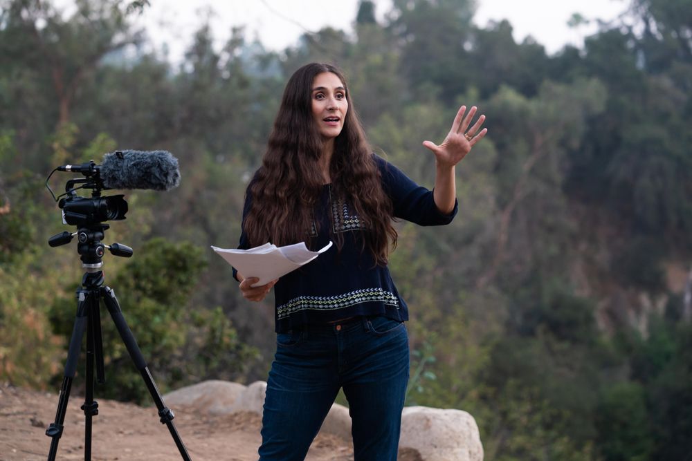 Female director giving feedback while filming outside