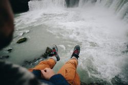 Legs hanging over cliff
