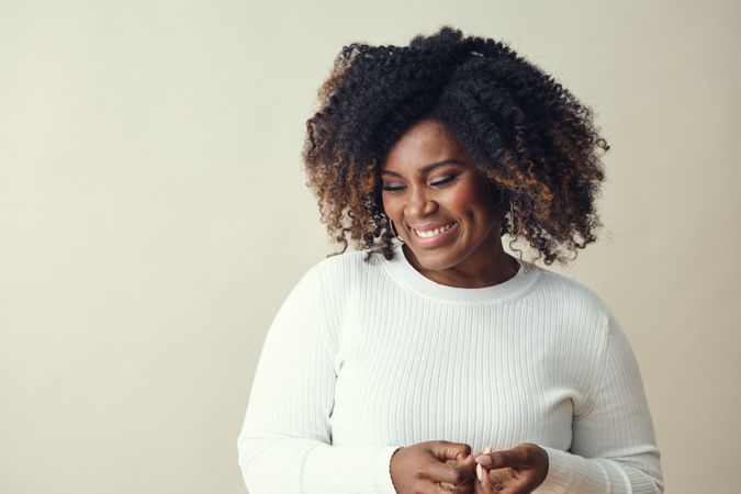 Portrait of relaxed Black woman looking down and smiling