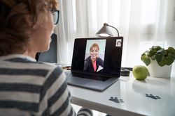 Crop boy having video chat with teacher via laptop