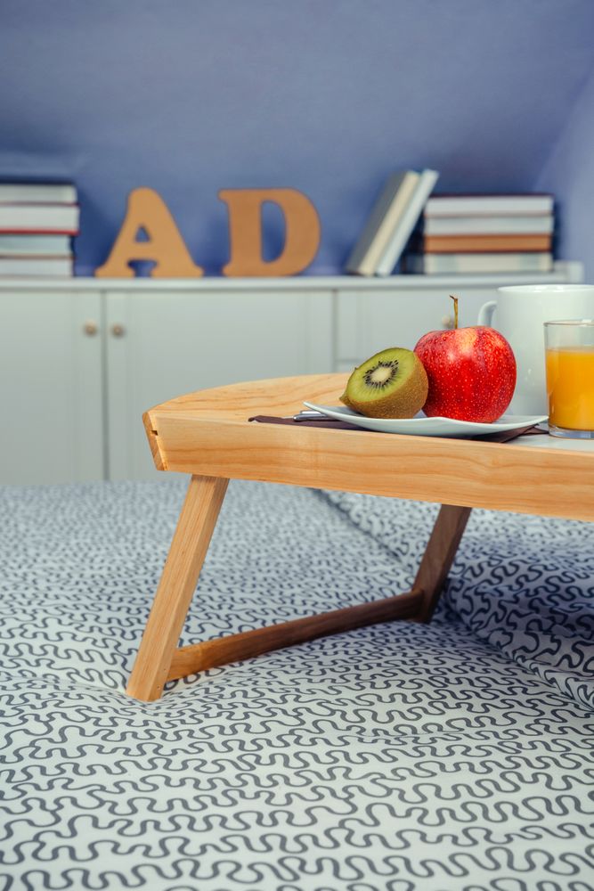 Bed tray with breakfast for two on bed
