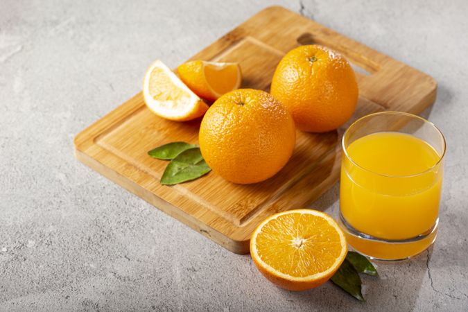 Glass with orange juice on the table.