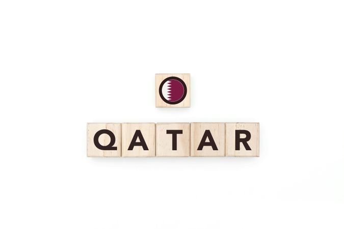 Wooden blocks bearing the name and flag of Qatar.