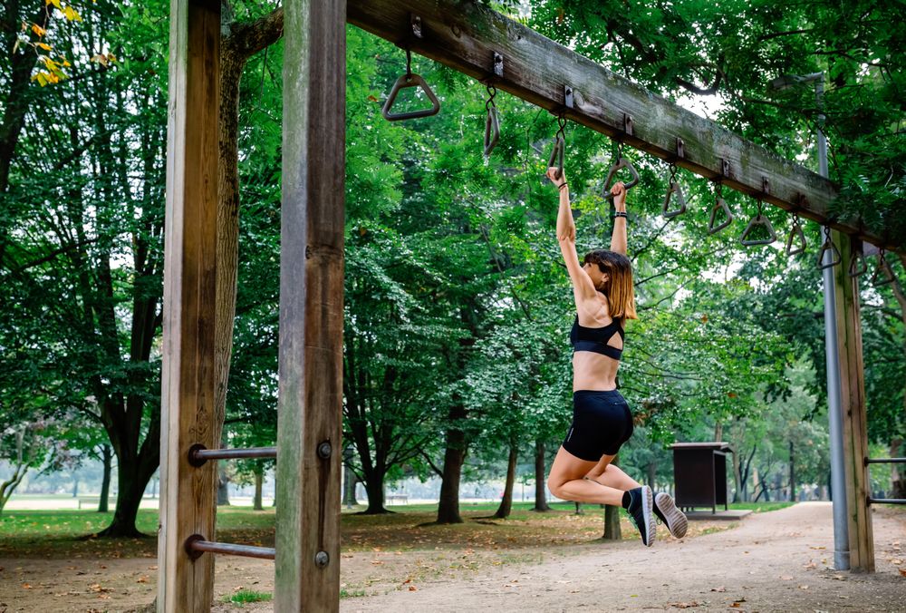 Woman doing monkey exercises on rings