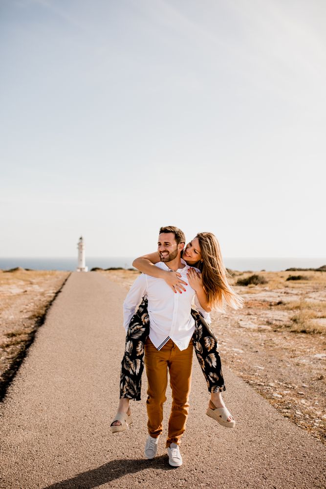Happy lovers having fun on path from sea