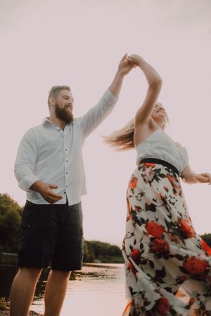 Loving couple standing ankle deep in water on beach