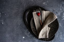 Top view of table setting with heart ornament and napkin