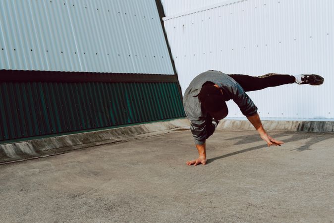 Man performing handstand near wall