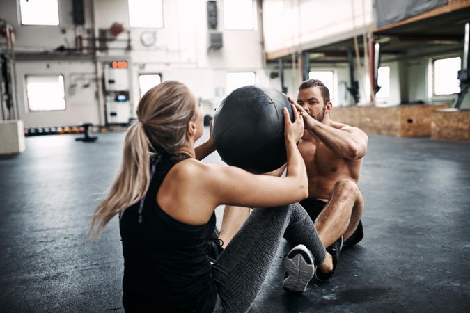 Man and woman working out with medicine ball